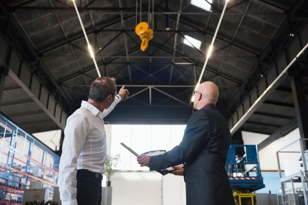 two-businessmen-with-clipboard-on-factory-shop-flo-2024-09-15-15-48-26-utc
